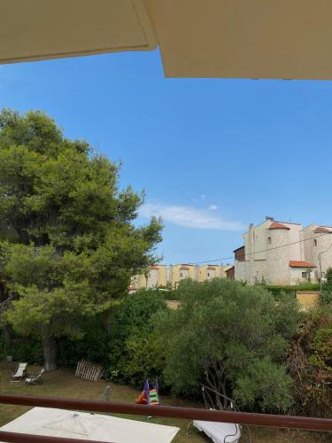 a view of a park with a tree and buildings at Casa StefanoS in Afitos