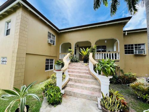 a house with a staircase in front of it at Labor of Love in Christiansted