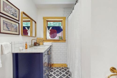 a bathroom with a sink and a shower at Turner Hill Cottage in West Townshend