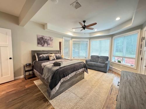 a bedroom with a bed and a ceiling fan at Mitten Pines Cabin Hot Tub Fire Pit in Conway