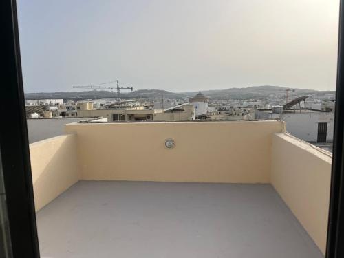 a balcony with a view of a city at Bright & Airy 3 Bedroom Apartment in Naxxar