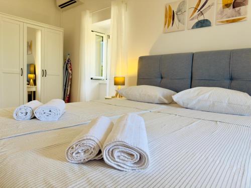 a white bed with towels on top of it at Holiday Home Vista Natura in Labin