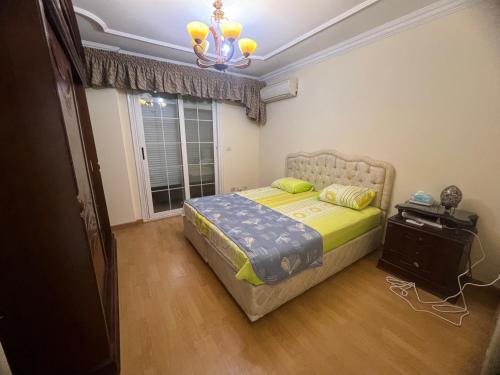 a bedroom with a bed and a window at The Cozy Garden Retreat in New cairo