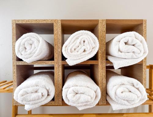a bunch of towels are on a shelf at Índigo 7, Steps from Playa Brujas Beach in Mazatlán