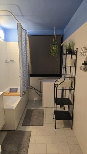 a living room with a tv and a shelf with a plant at Pakri apartment in Paldiski