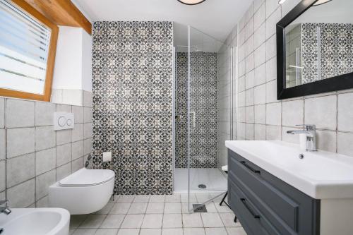 a bathroom with a shower and a toilet and a sink at Villa Cangarela in Višnjan