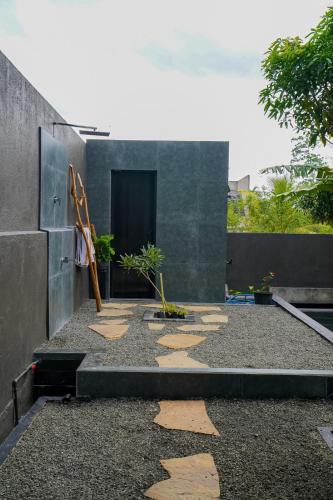 a building with a courtyard with stepping stones on the ground at Luna Living Galle in Galle