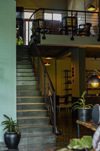 a spiral staircase in a building with chairs on it at Luna Living Galle in Galle