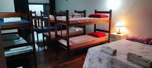 Postel nebo postele na pokoji v ubytování Suites Quartos Lindos Sobrado com Piscina no Centro