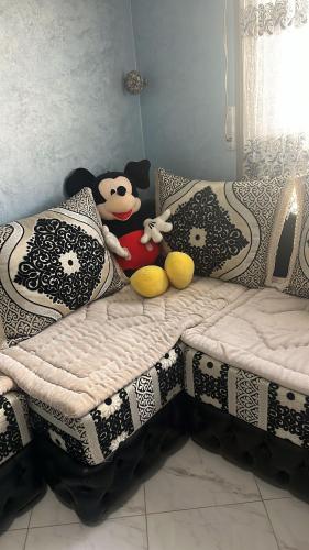a bed with two stuffed animals sitting on it at Apartment nador mattar in Nador