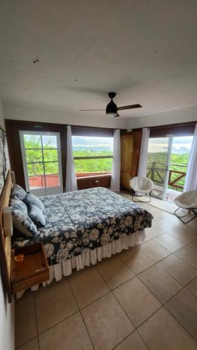 a bedroom with a bed and a large window at Mi Verde Horizonte in Utuado