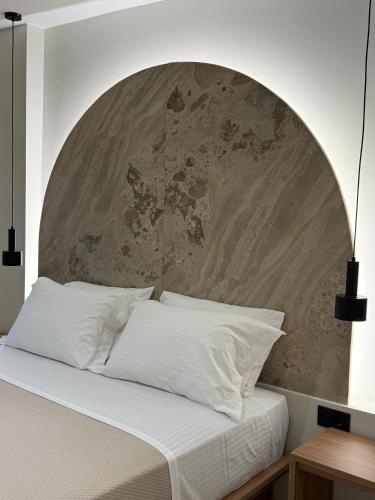 a bedroom with a bed with a large headboard at Theros Residence in Stavros