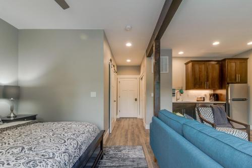 a living room with a blue couch and a kitchen at Johnson Street Studio in McMinnville
