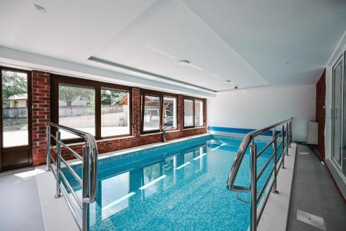 a swimming pool with windows and a brick wall at EMI Lokve in Homer