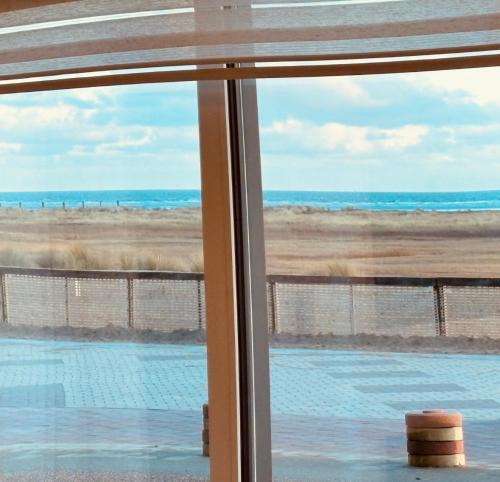 a view of the beach from a window at SEA VIEW Juweeltje in Knokke-Heist