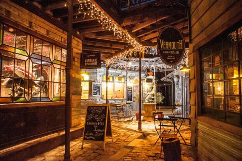 a restaurant with tables and chairs in a room with lights at Departamentos de El Mercado in Villa La Angostura