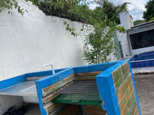 a blue bench with a water faucet next to a building at Honda-Tolima in Honda