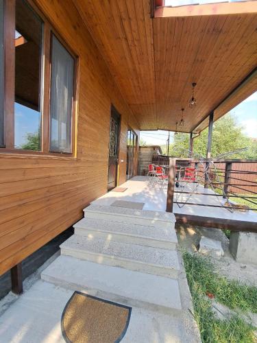 a porch of a house with stairs and windows at Oda in Mtskheta in Mtskheta