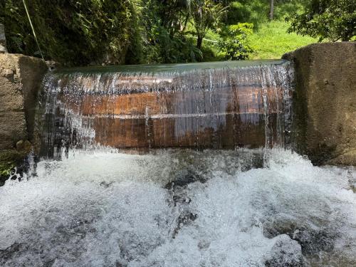 a water fall with water coming out of it at Hotel Selva Cristal in San Carlos