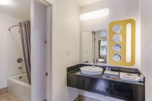 a bathroom with a sink and a mirror at Americas Best Value Inn Bowling Green in Bowling Green