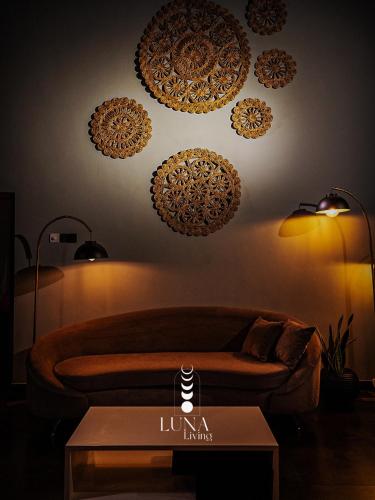 a living room with a couch and a table at Luna Living Galle in Galle