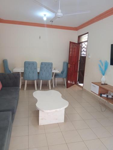 a living room with a couch and chairs and a table at Mtwapa Luxurious 3 Bedroom with Pool in Mombasa