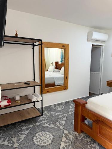a bedroom with a mirror and a bed at Eco hotel el bosque in Doradal