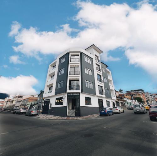 a tall white building on the side of a street at Sofisticado Departamento Central en Loja in Loja
