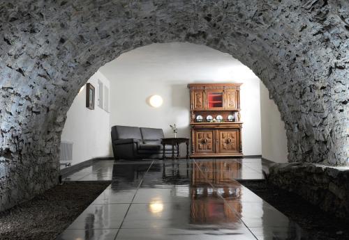 an archway in a living room with a chair and a cabinet at Schloss Purschenstein in Neuhausen