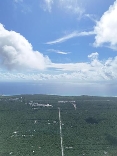 an aerial view of a road in a field at Loft Pelicano - Santuario Apartments in Chemuyil