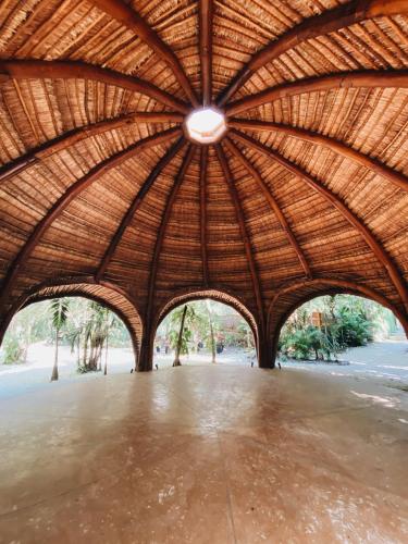 a large bamboo roofed pavilion with a light in the center at Loft Pelicano - Santuario Apartments in Chemuyil