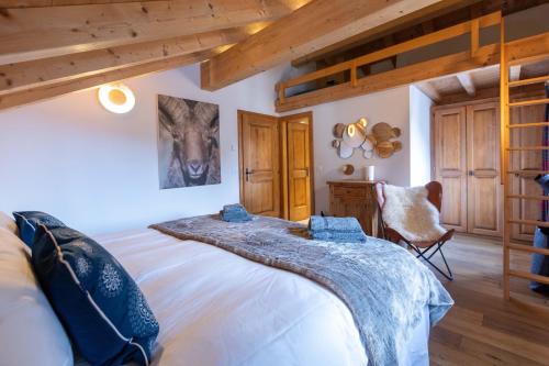 a bedroom with a large bed in a room with wooden ceilings at Balthazar The Loft by Villars Luxury in Villars-sur-Ollon