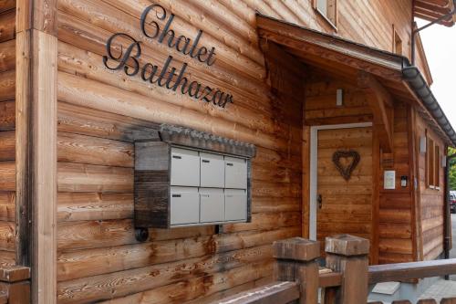 a log cabin building with a sign on it at Balthazar The Loft by Villars Luxury in Villars-sur-Ollon