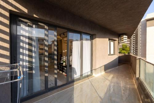 a balcony of a house with glass windows at B15/87/31 · 3BR Haven in B15 Madinaty in Madinaty