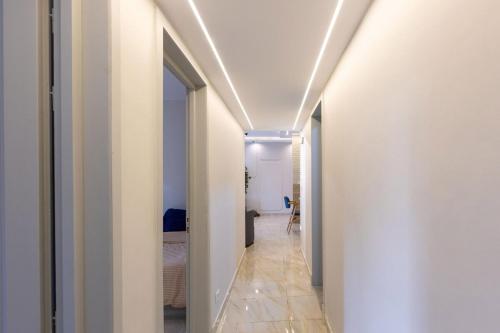 a hallway with white walls and a ceiling with lights at B15/87/31 · 3BR Haven in B15 Madinaty in Madinaty