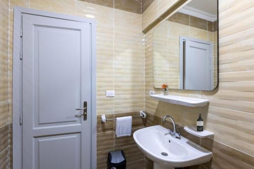 a bathroom with a sink and a mirror at B15/87/31 · 3BR Haven in B15 Madinaty in Madinaty
