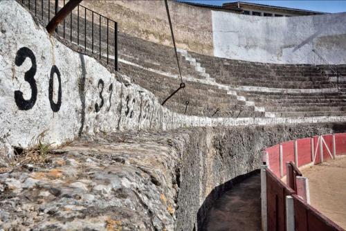 a concrete retaining wall with stairs and a fence at Casa Ariadna in Bocairent