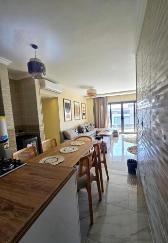 a kitchen and living room with a table and chairs at B15/87/51 · Madinaty B15 Brand new 3BR Apt in Madinaty