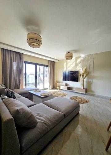 a living room with a couch and a tv at B15/87/51 · Madinaty B15 Brand new 3BR Apt in Madinaty