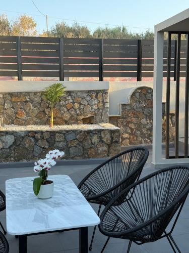 a patio with a table and two chairs at Theros Residence in Stavros