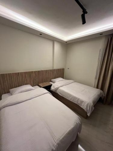 two beds in a hotel room with white sheets at B15/172B/41 · Spacious 3BR @ Madinaty b15 in Madinaty