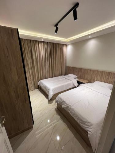a hotel room with two beds and a window at B15/172B/41 · Spacious 3BR @ Madinaty b15 in Madinaty