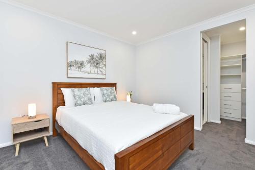 a bedroom with a large bed and a night stand at Huntlee Heights in North Rothbury