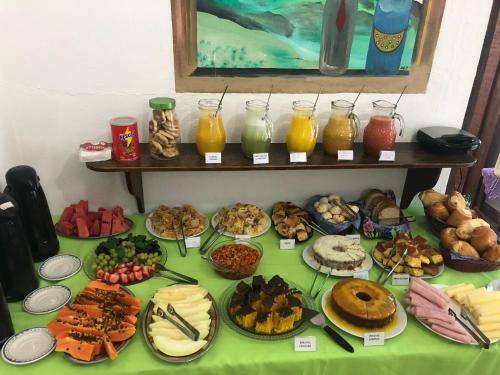 a table topped with lots of different types of food at Pousada Alegre Pinheirinho in Tiradentes