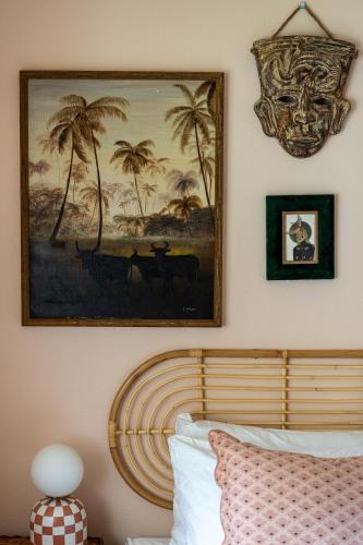 a bedroom with a painting on the wall and a bed at Stylized Captain's House in Captain Cook