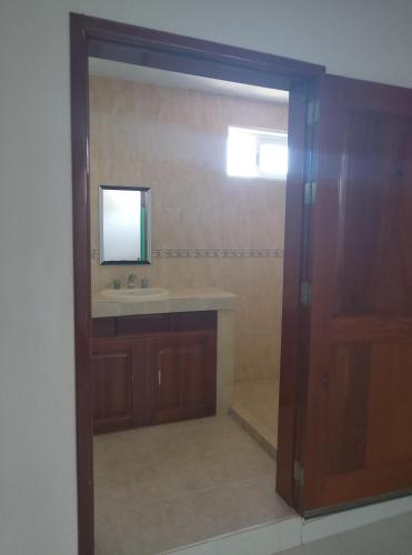 a bathroom with a sink and a mirror at F H Hostel in Chetumal