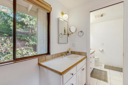 a bathroom with a sink and a window at The Canopy House in Eugene