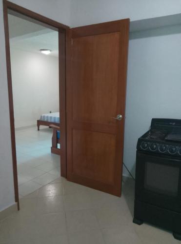 a door leading into a room with a stove at F H Hostel in Chetumal