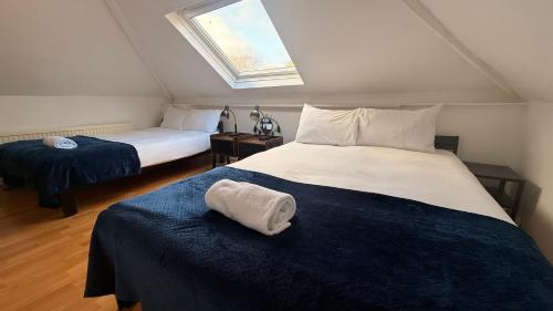a bedroom with two beds and a window at Central located house for big groups in Bristol