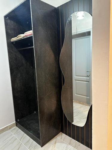 a bathroom with a large mirror on the wall at B15/87/41 · Brand New 3BR Stylish Madinaty in Madinaty